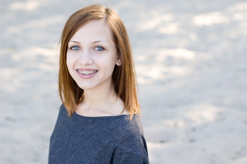 Beautiful girl wearing braces and smiling charmingly